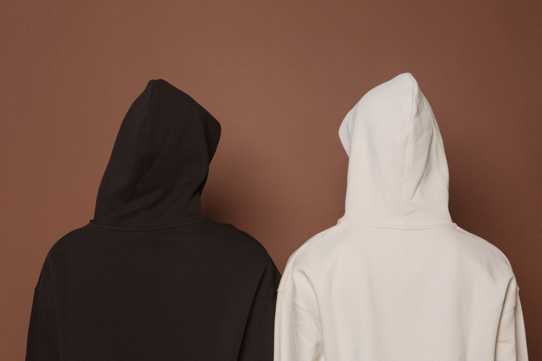 Models and black and white hoodies in studio